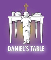 Daniel's Table logo on a background of their signature purple color ( a saturated screen tone) The logo consists of a small boy reaching up to a table that has a glass of milk, a bowl of rice, and a loaf of bread set atop. Above the boy and table is a cross. Beneath the boy's feet are the words "Daniel's Table".